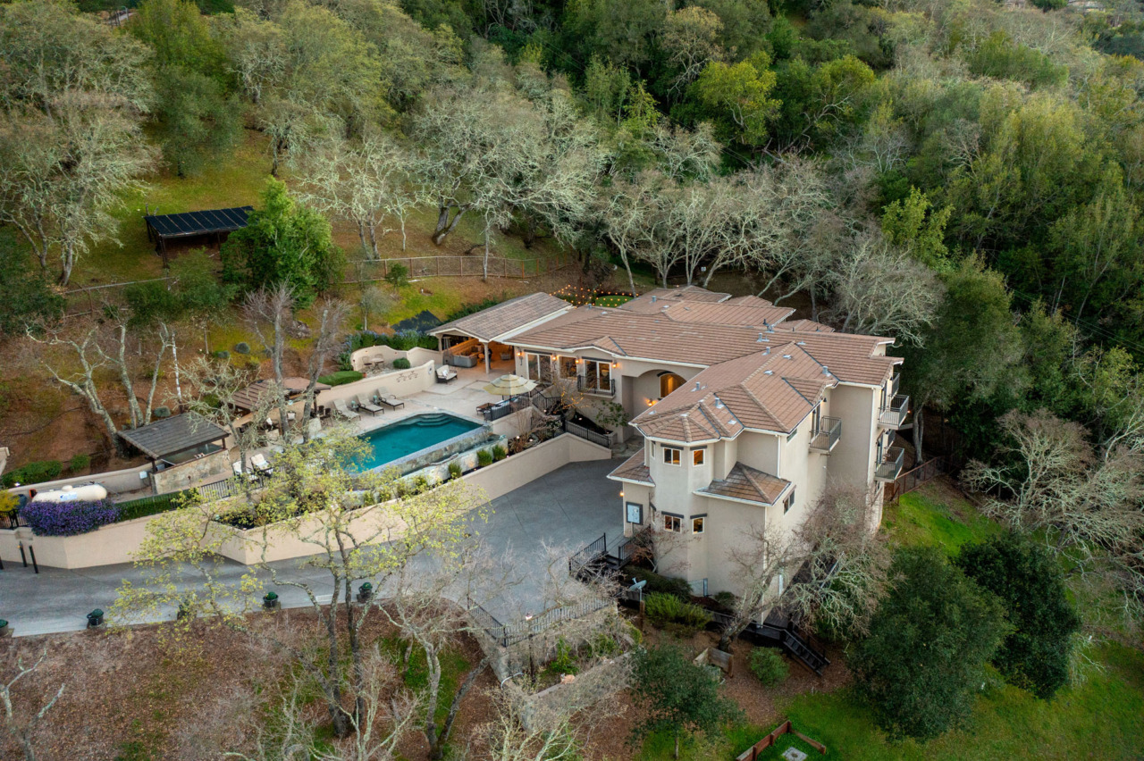 21290 Cinnabar Hills Road, aerial view of house and pool amidst trees