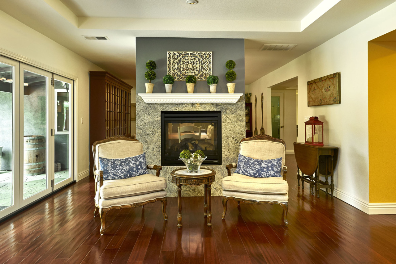 6711 Landerwood Lane - seats in front of dual fireplace in living room